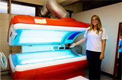 Staff standing next to tanning machine